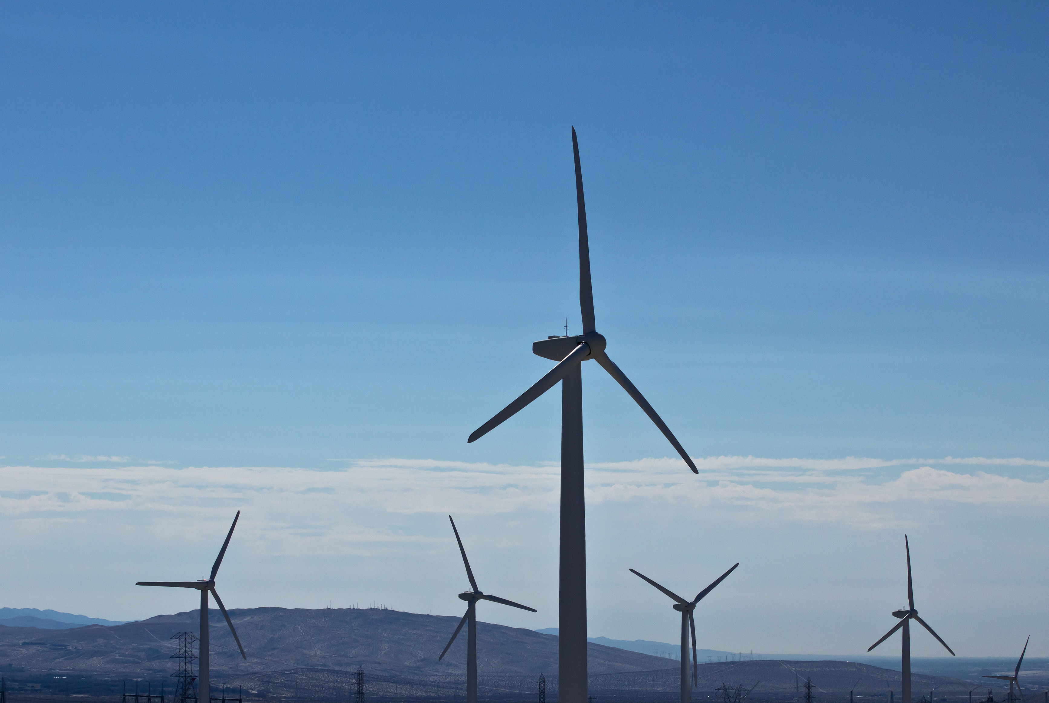 Wind turbines standing over open land